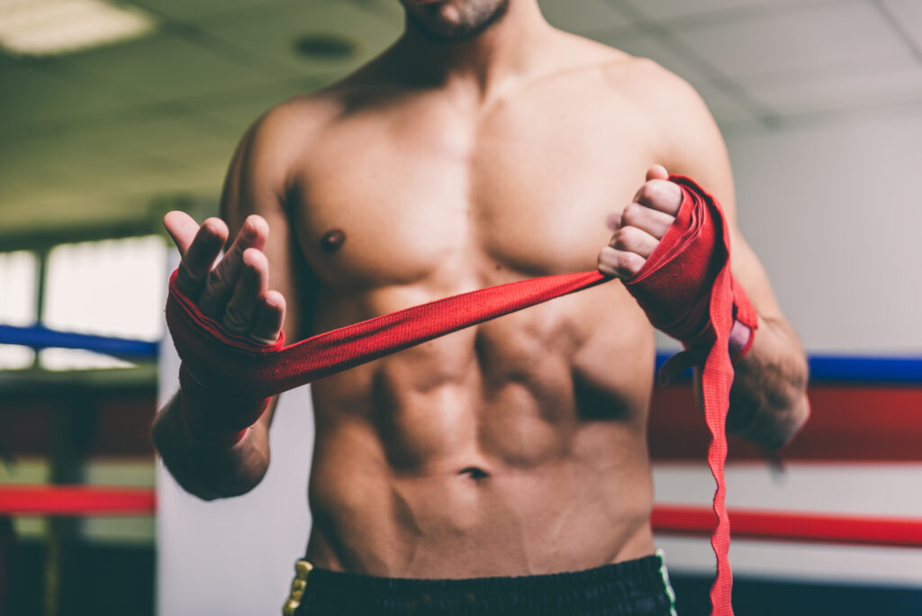 Boxer wrapping hands before training